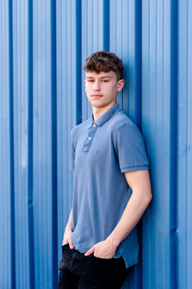 senior portrait of a high school boy wearing a blue shirt in Dunedin